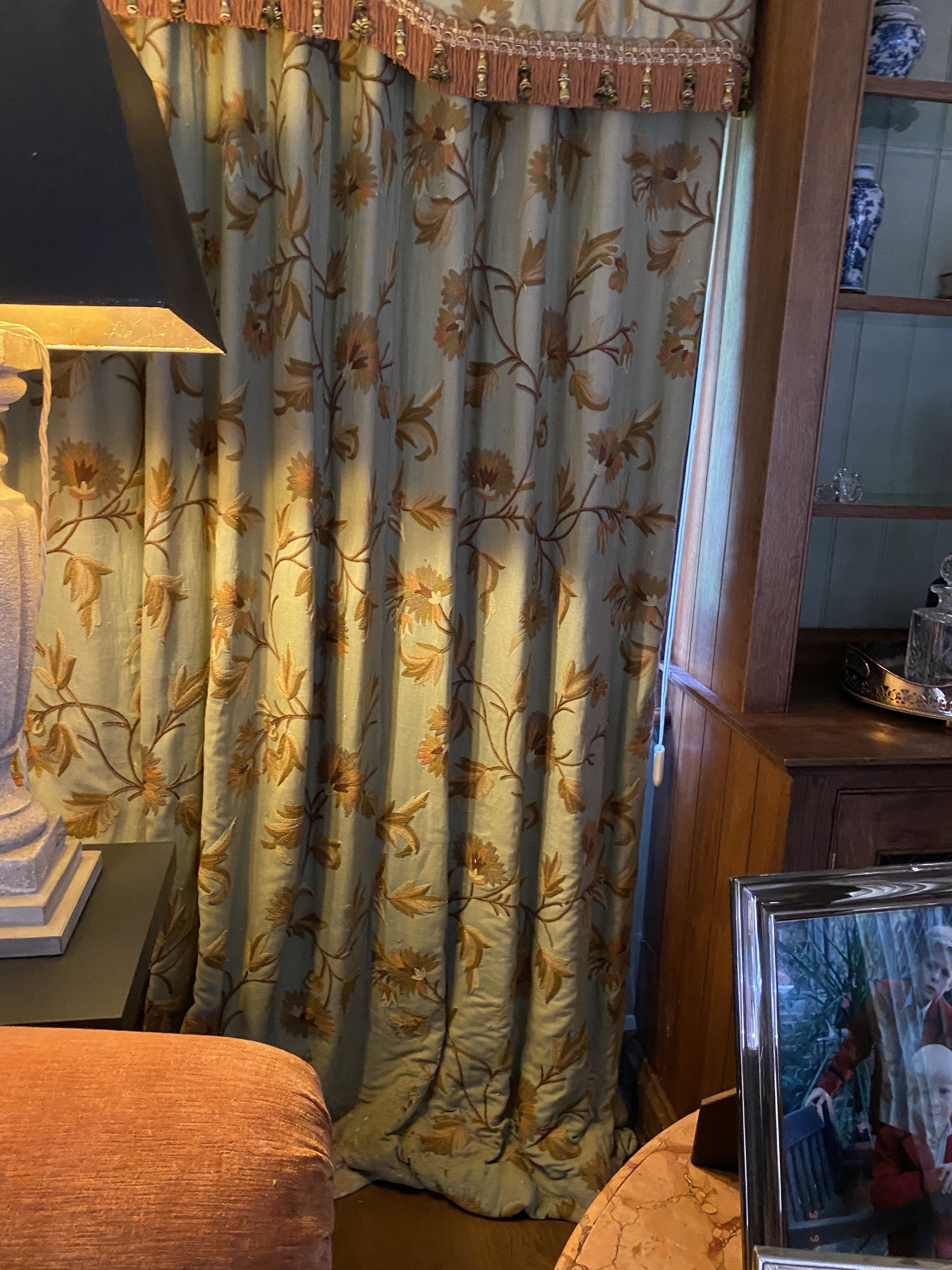 A pair of eau de nil linen curtains with floral crewel work decoration, and matching two piece pelmet, drop 230cm, generously made to fit an aperture of 3.6m